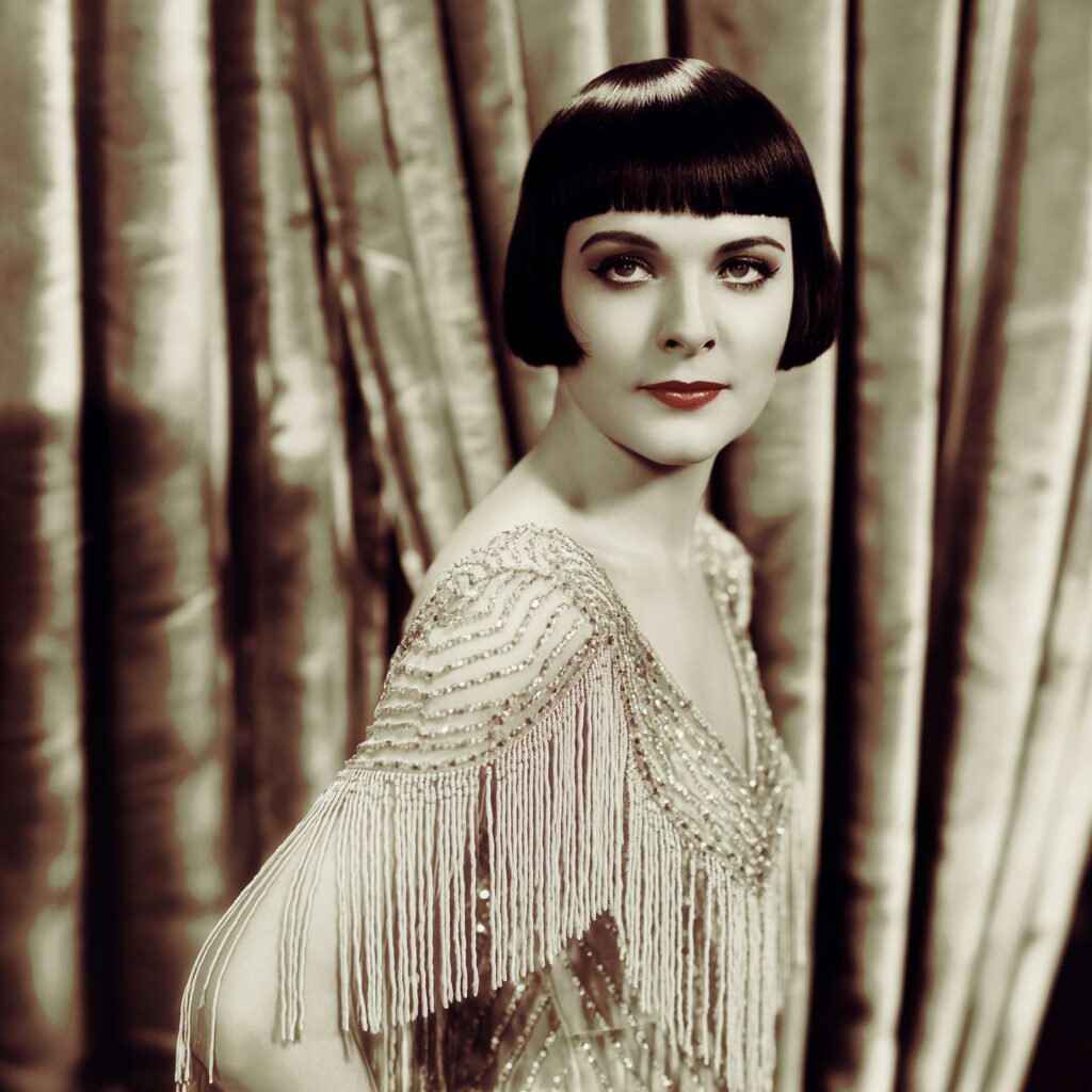 1920s silent film era beaded dress worn by stars like Clara Bow and Louise Brooks, showcasing iconic glamour