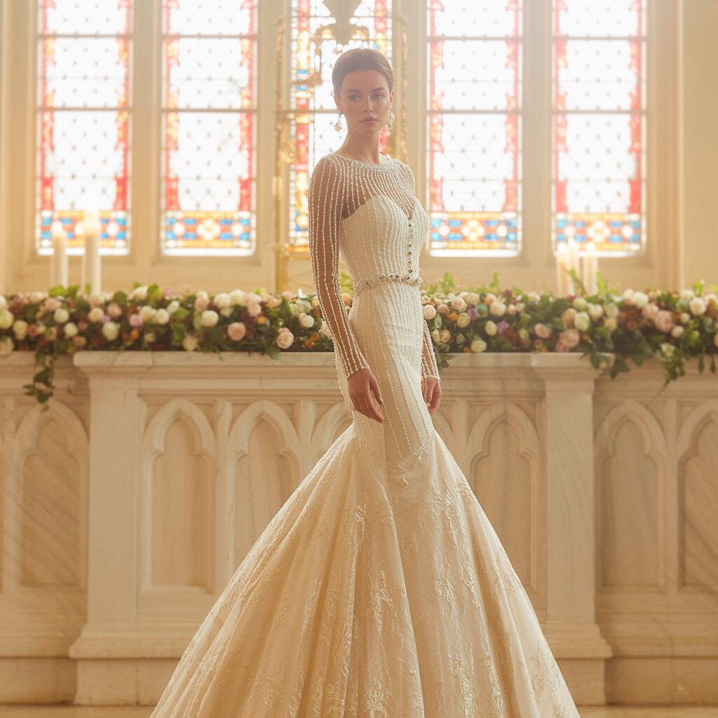 Back view of long sleeve mermaid wedding dress featuring lace or illusion detailing